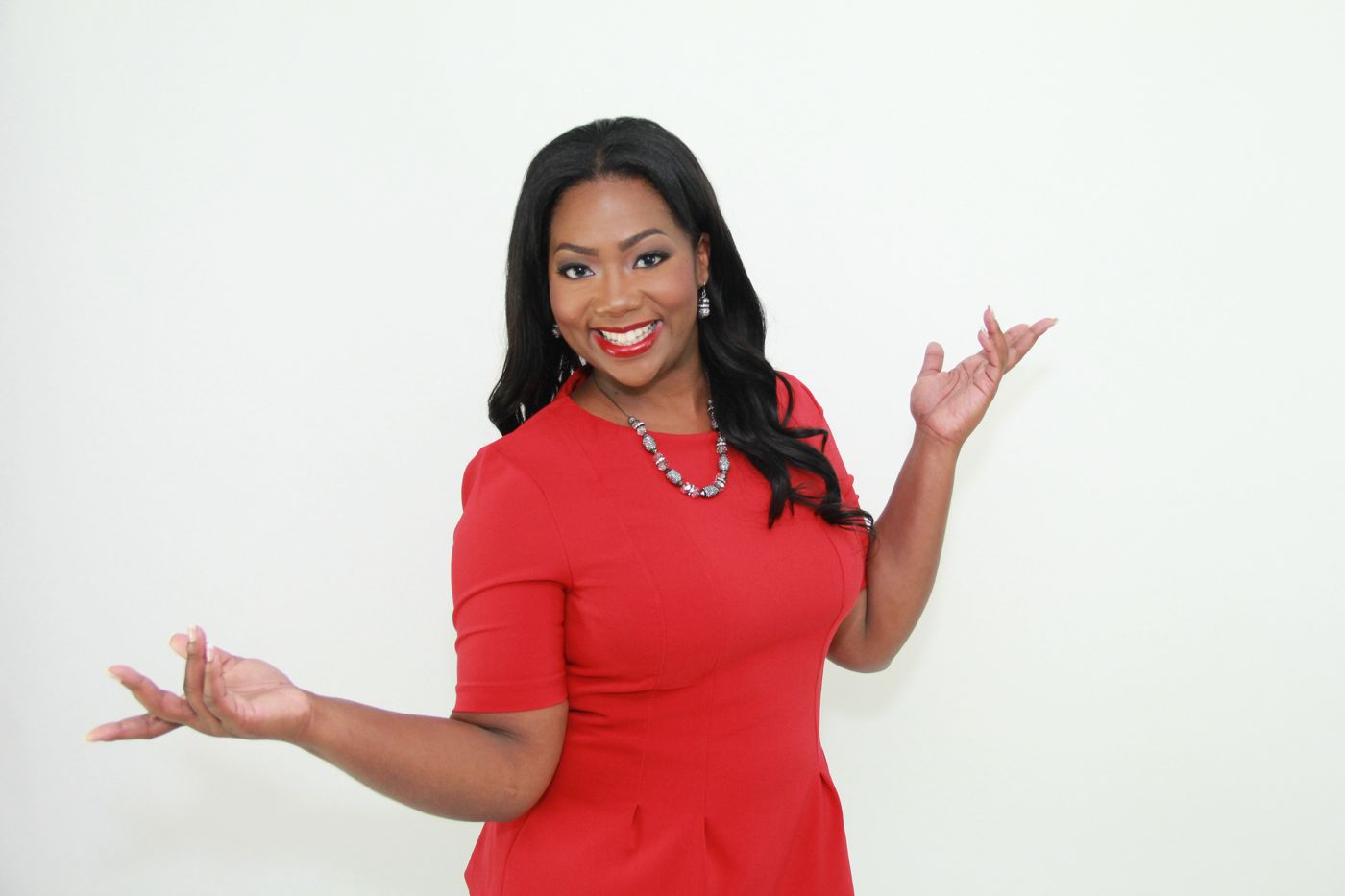 Jocelyn Dena’e with her arms open wide, smiling